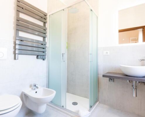 Badezimmer mit Eckdusche im Hotel Regina in Caorle im 4. Stock